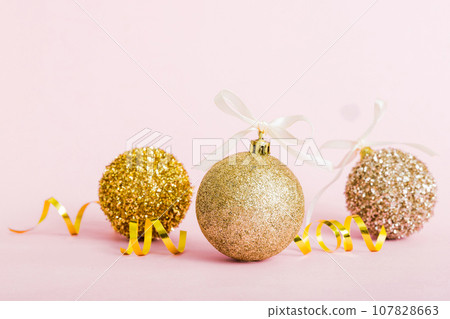 Christmas ball on colored background. decoration bauble with ribbon bow with copy space Christmas ball on colored background. decoration bauble with ribbon bow with copy space 107828663