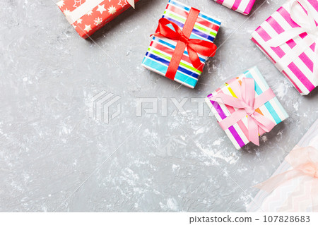 Top view of Christmas background made of gift boxes on cement background. New year holiday concept with copy space 107828683