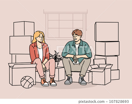 Couple sitting among boxes of belongings after moving into new house or apartment 107828693
