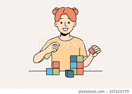 Happy little girl playing with wooden child cubes standing at table and smiling looking at screen Happy little girl playing with wooden child cubes standing at table and smiling looking at screen 107828770