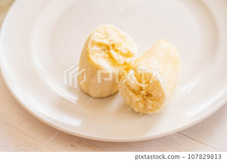 torn banana on a plate 107829813