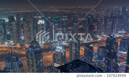 JLT and Dubai marina skyscrapers near Sheikh Zayed Road aerial day to night timelapse. Residential buildings JLT and Dubai marina skyscrapers near Sheikh Zayed Road aerial day to night timelapse. Residential buildings 107829999