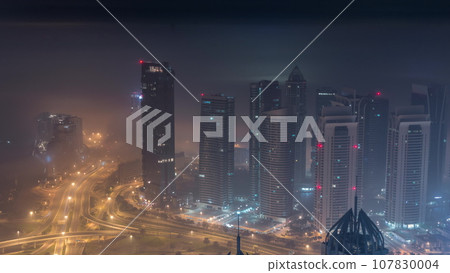 JLT and Dubai marina skyscrapers near Sheikh Zayed Road aerial all night timelapse. Residential buildings JLT and Dubai marina skyscrapers near Sheikh Zayed Road aerial all night timelapse. Residential buildings 107830004