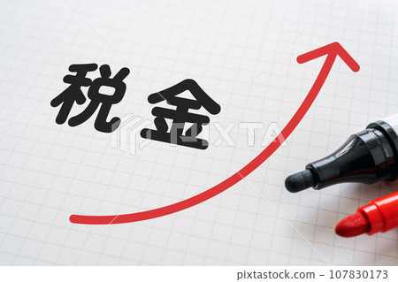 Notebook and marker with tax and upward arrow written on it Notebook and marker with tax and upward arrow written on it 107830173