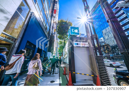 Tokyo cityscape in Japan: Bustling Ginza in October. Ginza Station entrance B4 in front of Ginza Chuo Building is shuttered. 107830907