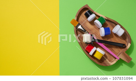 Plastic jars with multi-colored gouache, copy space 107831094