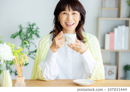 A woman with a coffee cup A woman with a coffee cup 107831444