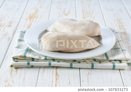 Boiled chicken breast in a plate, selective focus on light wooden table. Boiled chicken breast in a plate, selective focus on light wooden table. 107833273