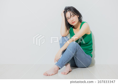 Woman in green tank top Woman in green tank top 107833347