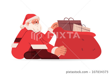 santa claus in red costume sitting on floor near sack full of gift boxes happy new year merry christmas holidays celebration concept 107834373