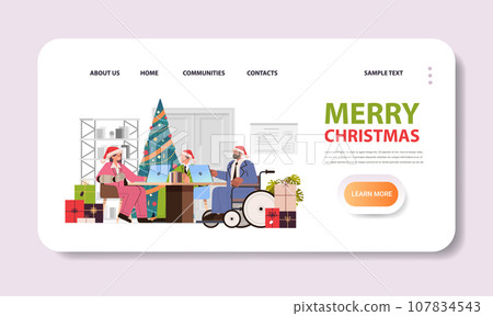 disabled man in wheelchair and woman with replaced robotic arm wearing santa claus hats working on laptops people with disabilities merry christmas 107834543