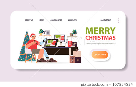 disabled man in santa claus hat graphic designer with replaced robotic leg and arm guy working on laptop people with disabilities 107834554