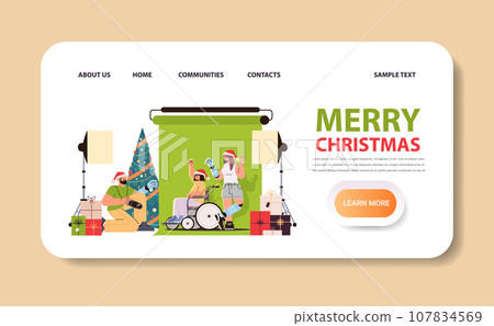 disabled man photographer in santa claus christmas hat doing photo of models with replaced robotic body parts in photo studio people with disabilities 107834569