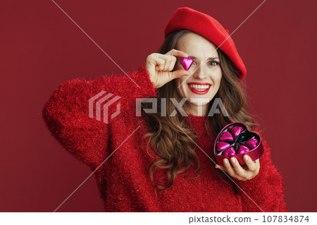 happy modern woman in red sweater and beret 107834874