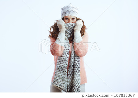 stylish female wrapping up in scarf on white stylish female wrapping up in scarf on white 107835367