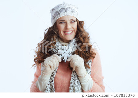 happy trendy woman in sweater, mittens, hat and scarf on white 107835376