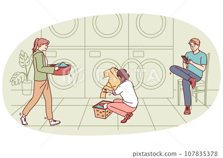 People washing clothes in laundromat People washing clothes in laundromat 107835378