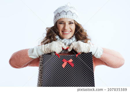 smiling trendy woman in sweater, mittens, hat and scarf on smiling trendy woman in sweater, mittens, hat and scarf on 107835389
