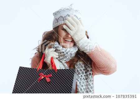 excited stylish woman in sweater, mittens, hat and scarf excited stylish woman in sweater, mittens, hat and scarf 107835391