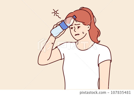 Woman who gets heatstroke on walk puts bottle of water to forehead and needs to rest or see doctor Woman who gets heatstroke on walk puts bottle of water to forehead and needs to rest or see doctor 107835481