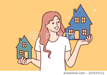 Woman realtor holds two houses offering to choose property she likes and arrange mortgage or rent Woman realtor holds two houses offering to choose property she likes and arrange mortgage or rent 107835532