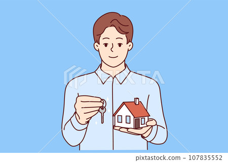 Man real estate broker holds keys and model house offering to take out mortgage on favorable terms Man real estate broker holds keys and model house offering to take out mortgage on favorable terms 107835552