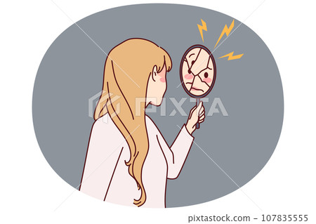 Woman looking in broken mirror 107835555