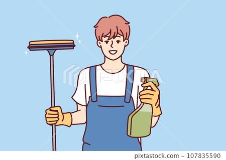 Happy man window cleaner holds spray bottle with detergent and mop for cleaning glass Happy man window cleaner holds spray bottle with detergent and mop for cleaning glass 107835590