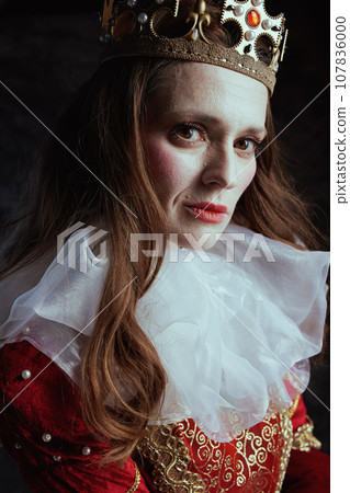 medieval queen in red dress with white collar and crown 107836000