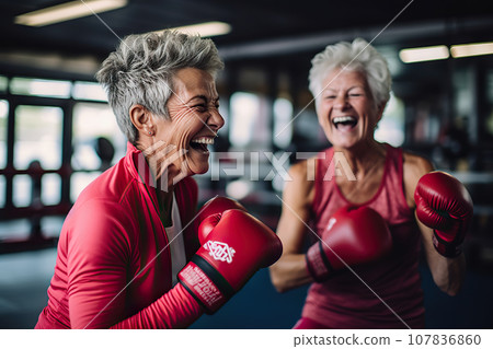 Age-Defying Strength A Senior Woman Boxer, Showcasing Vitality and Resilience, Engages in Training with Her Coach, Confidently Breaking Stereotypes Through Active Exercise. created with Generative AI 107836860
