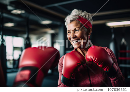 Age-Defying Strength A Senior Woman Boxer, Showcasing Vitality and Resilience, Engages in Training with Her Coach, Confidently Breaking Stereotypes Through Active Exercise. created with Generative AI 107836861