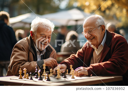 Elderly Friends Embrace Intellectual Challenge, Engaging in Outdoor Chess Game, Celebrating Senior Vitality and Lifelong Companionship. created with Generative AI 107836932