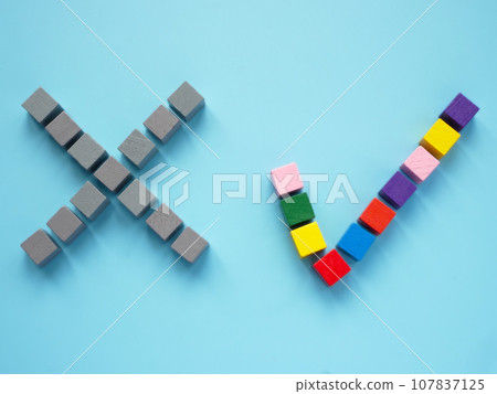 A no sign made of gray cubes and yes sign made of multi-colored ones as a concept of inclusion. 107837125