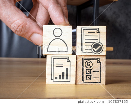 Hand holds a cube as symbol of hiring of competent employee or evaluation. Hand holds a cube as symbol of hiring of competent employee or evaluation. 107837165