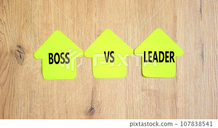 Boss vs leader symbol. Concept words Boss vs versus leader on beautiful yellow paper house. Beautiful wooden background. Business motivational boss vs leader concept. Copy space. Boss vs leader symbol. Concept words Boss vs versus leader on beautiful yellow paper house. Beautiful wooden background. Business motivational boss vs leader concept. Copy space. 107838541