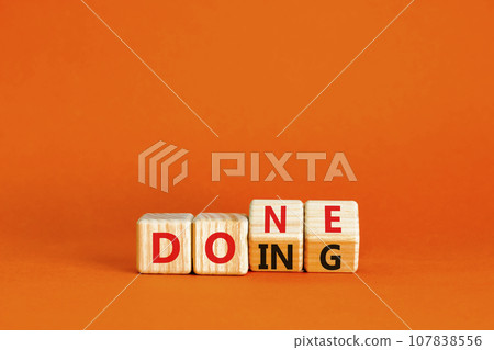 Doing and done symbol. Concept words Doing Done on wooden block. Beautiful orange table orange background. Business doing and done concept. Copy space. Doing and done symbol. Concept words Doing Done on wooden block. Beautiful orange table orange background. Business doing and done concept. Copy space. 107838556