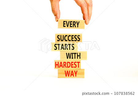 Success symbol. Concept words Every success starts with hardest way on wooden block. Beautiful white table white background. Businessman hand. Business success and hardest way concept. Copy space. Success symbol. Concept words Every success starts with hardest way on wooden block. Beautiful white table white background. Businessman hand. Business success and hardest way concept. Copy space. 107838562