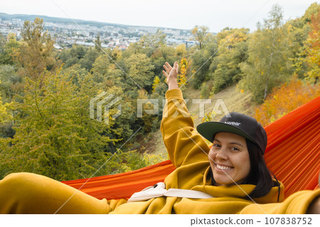 chilling woman laying down in hammock chilling woman laying down in hammock 107838752