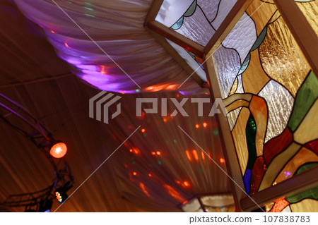 Colorful abstract stained glass window in tent 107838783