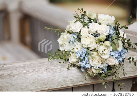 Wedding bouquet of roses on wooden background Wedding bouquet of roses on wooden background 107838790