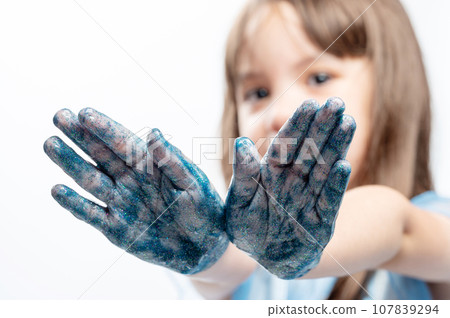 Happy kid with shiny painted hands Happy kid with shiny painted hands 107839294