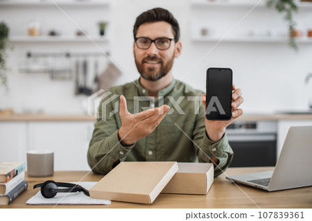 Male influencer unpacking new smartphone and live streaming Male influencer unpacking new smartphone and live streaming 107839361