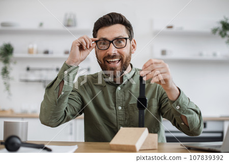 Male influencer recording video blog about new smart watch Male influencer recording video blog about new smart watch 107839392