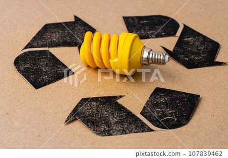 LED light bulb with recycle symbol on craft paper 107839462