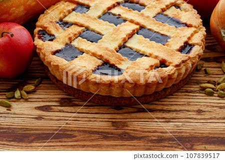 Close up of a berry tart pie on wooden table Close up of a berry tart pie on wooden table 107839517