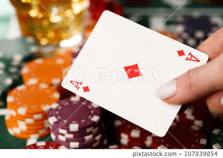 Female hand holding playing cards in casino Female hand holding playing cards in casino 107839854