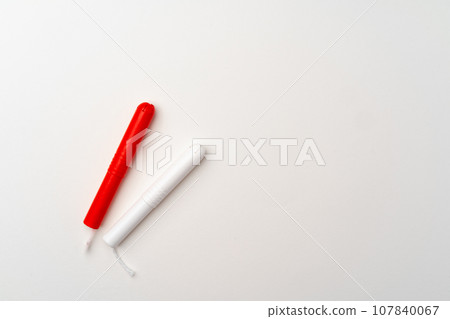 Red and white woman medical tampons on white background 107840067