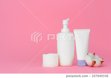 Stack of cotton discs and skicare cosmetic bottle 107840336
