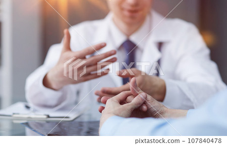 A close photo of the hands of a female patient 107840478
