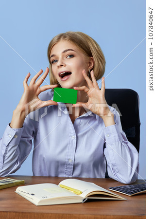 beautiful blonde businesswoman holding plastic credit card beautiful blonde businesswoman holding plastic credit card 107840647